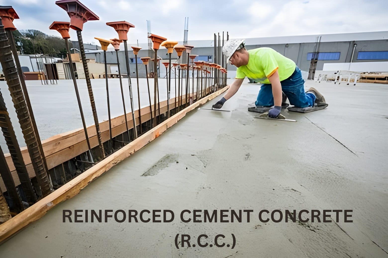 A construction worker smooths freshly poured concrete on a large slab, using a trowel. Rebar is visible for reinforcement, with a calm, focused atmosphere.